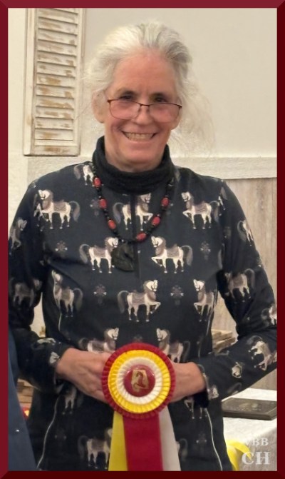 Photo of person holding horse show ribbon