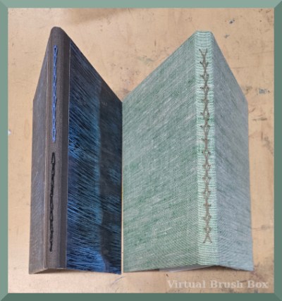 photo of two handmade books showing the fancy bindings