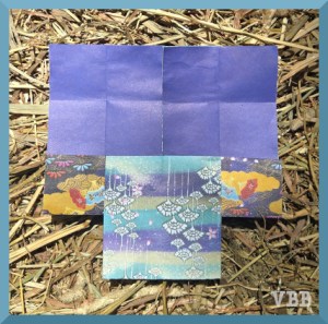 photo of pieces of origami paper on a hay bale