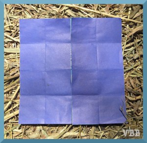 photo of pieces of origami paper on a hay bale