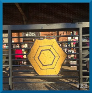 photo of crocheted hexagon hanging on a railing