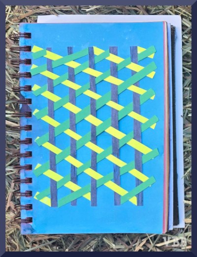 Photo of paper weaving with three colors inside a notebook