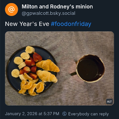 Plate with banana pieces, orange sections, strawberries, and croissants. Chocolate fondue.