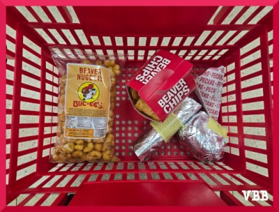 Red plastic shopping basket holding food from Buc-ees