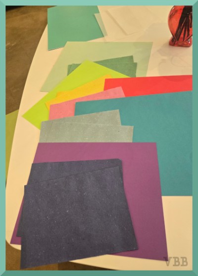 Photo of different colored sheets of paper spread out on a table.