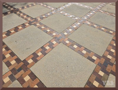 Photo of a sidewalk with a square mosaic pattern