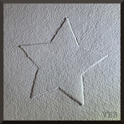 Photo of a piece of white watercolor paper with a raised star shape in the middle