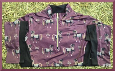 Photo of a purple long-sleeve, quarter zip shirt decorated with Chinese pottery style horse figures