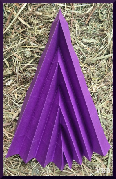 Photo of a sheet of purple paper folded into a pleated arrow