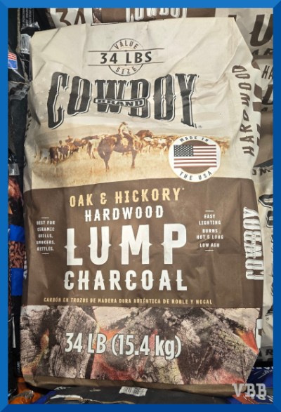 Photo of a bag of Cowboy Brand charcoal, showing a old-style photo of a cowboy on a horse with a herd of cows
