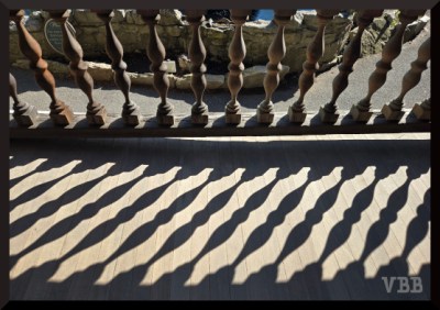 Photo of a wooden railing and shadow