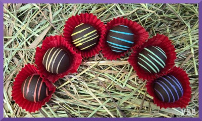 Photo of six chocolates in an semi-circle.