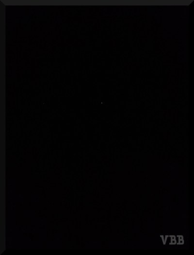 Photo of black sky with one small star in the middle.