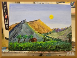 Photo of landscape painting on a metal easel.