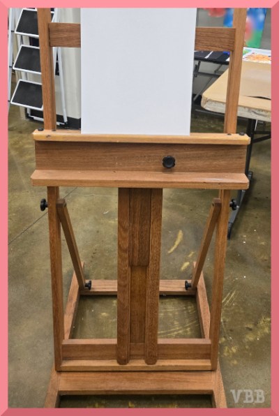 Photo of a blank canvas on a wooden easel.