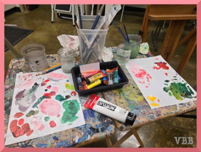Photo of tables with art supplies in use.