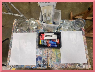 Photo of tables with neat art supplies.