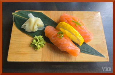 Photo of a salmon sushi order on a wooden tray