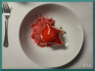 Photo of a peach dessert on a white plate.