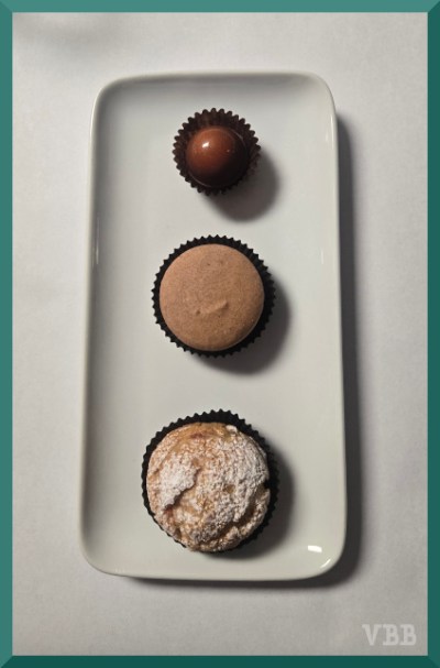 Photo of three sweets on a rectangular white plate.