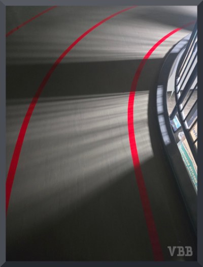 Photo of an indoor walking track with shadows.