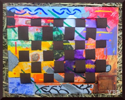 Photo of a canvas with multi-colored paint woven with brown ribbons.