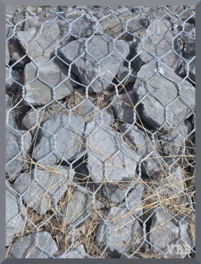 Photo of rocks in a pile wrapped in chicken wire.